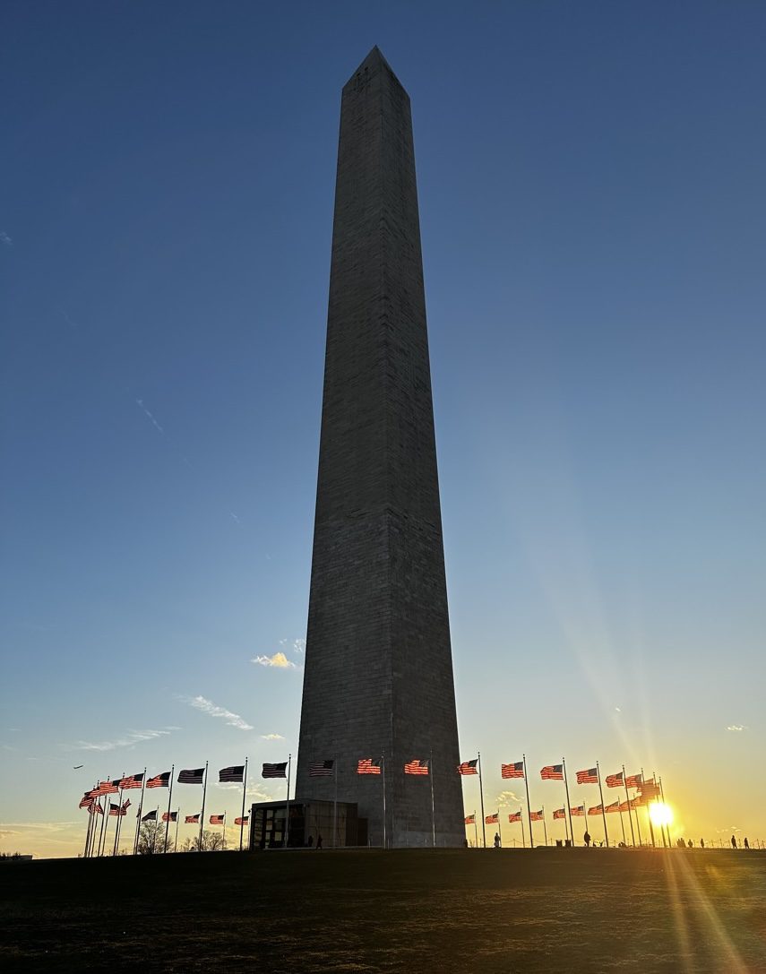 Washington Monument at sunset surrounded by American flags, Washington D.C.
