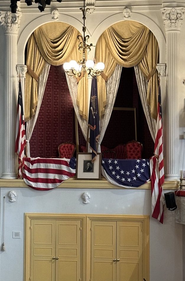 The Presidential Box at Ford's Theatre, draped in American flags with a portrait of George Washington