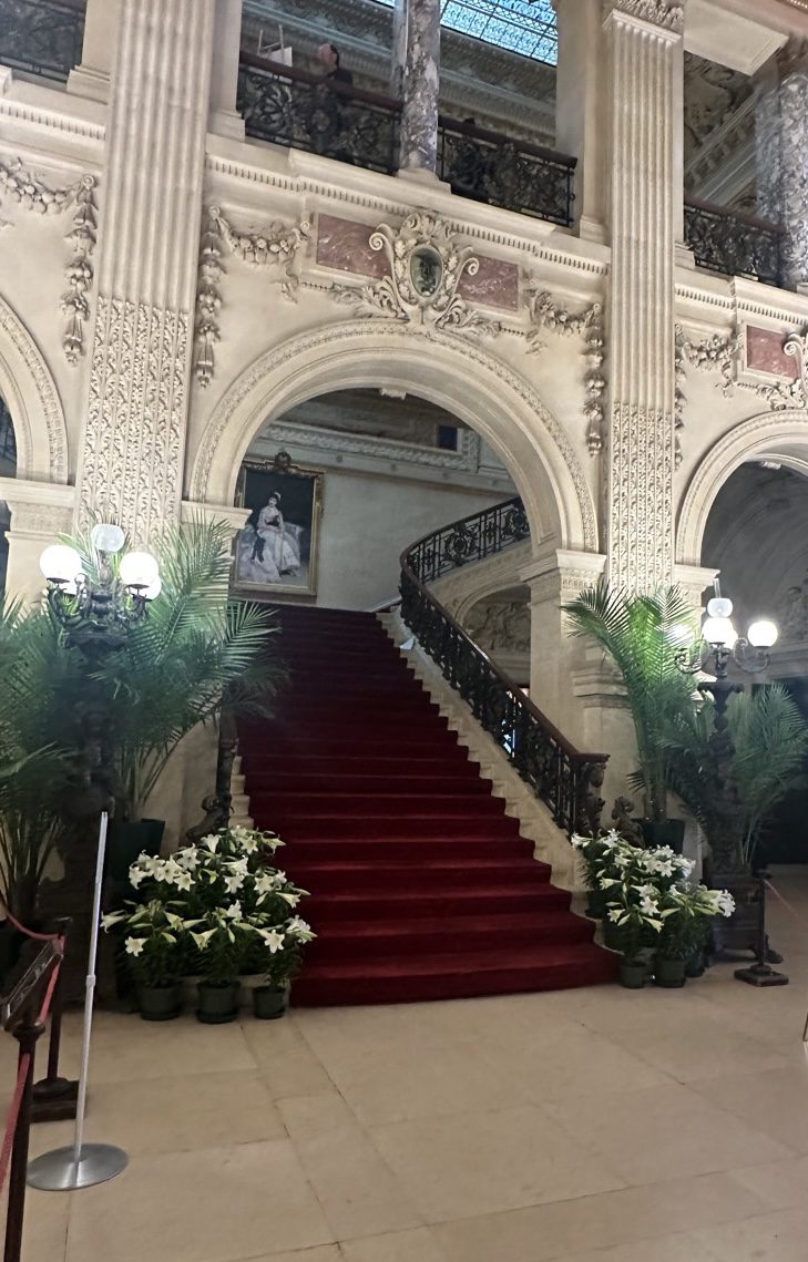 The Breakers Great Hall — grand staircase, red carpet, tapestry, ornate ceiling, Newport