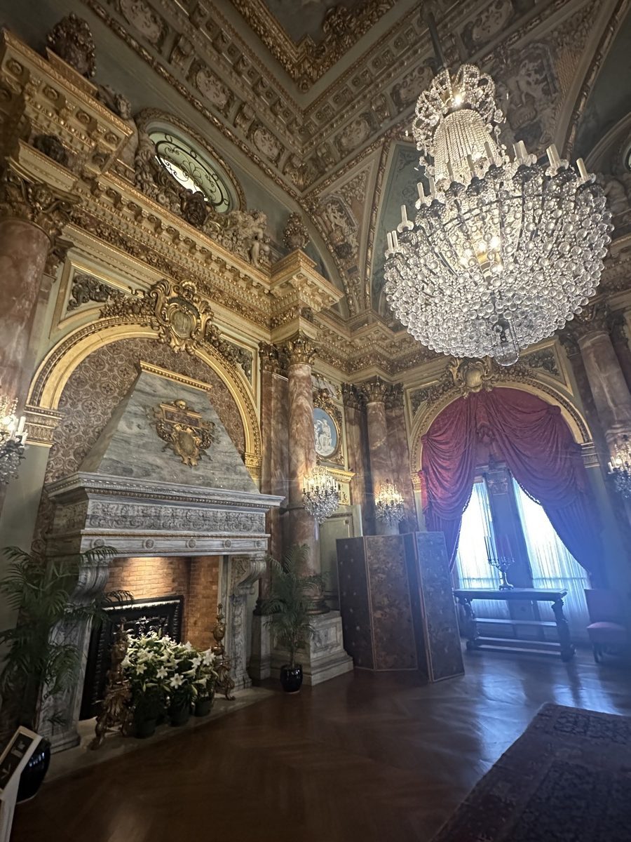 The Breakers music room or dining room — Baccarat crystal chandelier, gold ceiling, crimson drapes