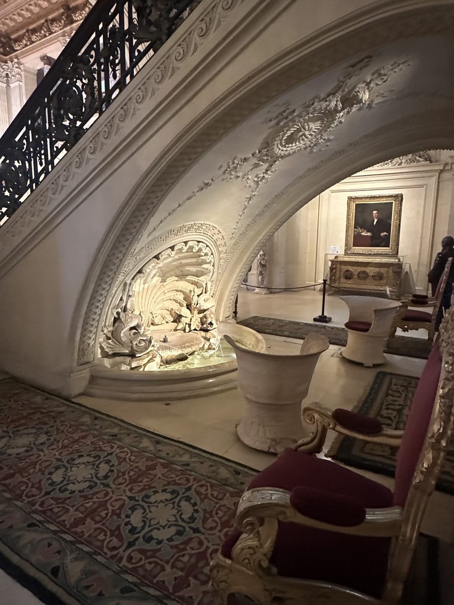 The Breakers grotto — carved marble seashells and dolphins under the grand staircase, lit from within