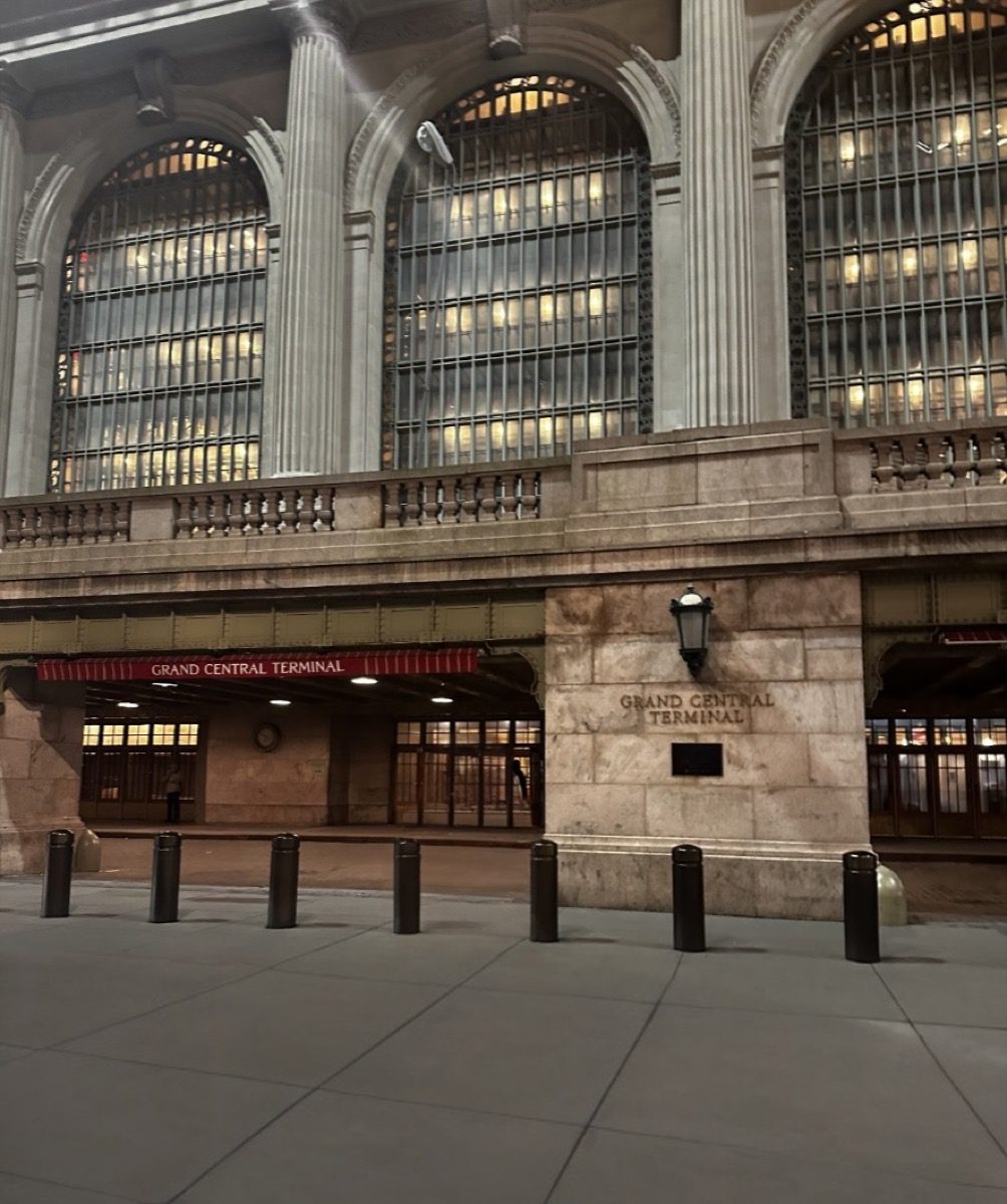 Grand Central Terminal exterior at night — arched windows, stone facade, Grand Central Terminal sign