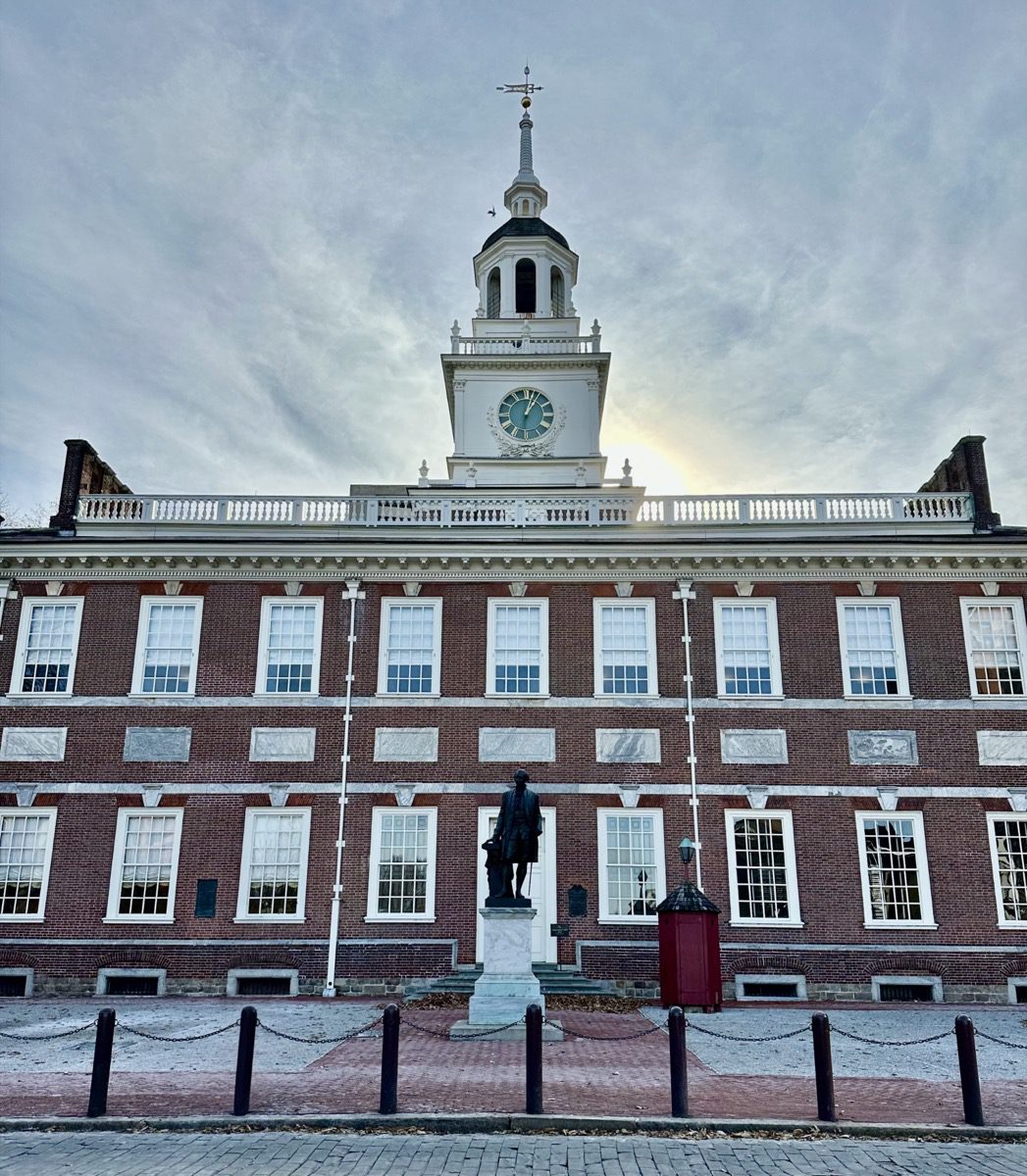 Independence Hall facade, empty courtyard, clock tower against an overcast sky